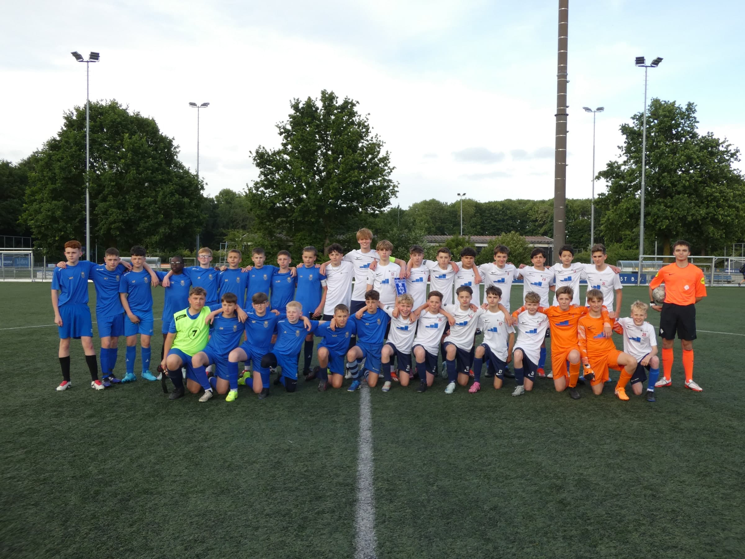 Two youth soccer teams lined up together after a friendly match